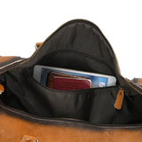 Open full grain leather duffle bag with tablet and passport in inner pocket, travel bag detail