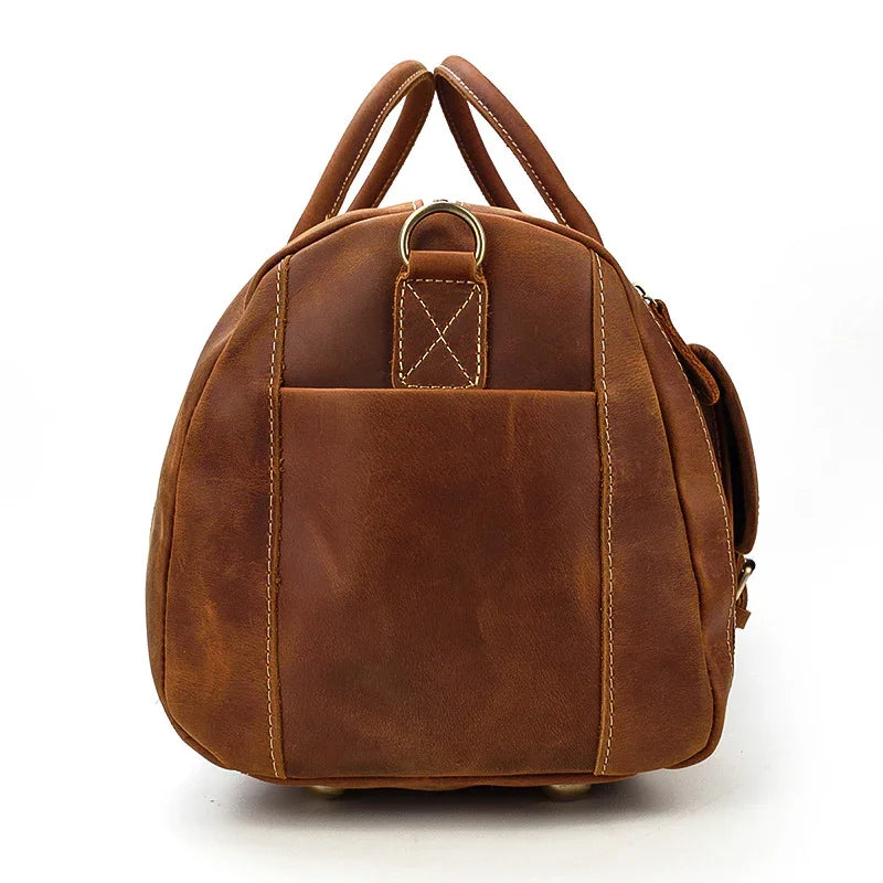 Side view of handmade full grain leather duffle bag in dark brown with sturdy handles