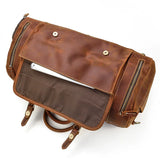 Handmade full-grain leather duffle bag in dark brown with front pocket and zip compartments