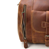 Close-up of brown full grain leather duffle bag with side zipper and front pocket
