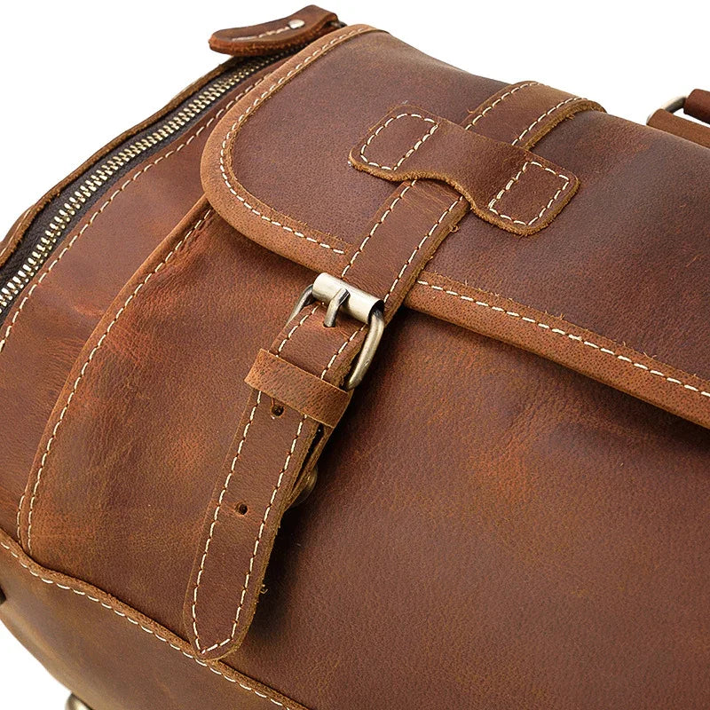 Close-up of a handmade full grain leather duffle bag with buckle and zipper details