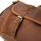 Close-up of a handmade full grain leather duffle bag with buckle and zipper details