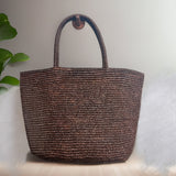 Raffia straw tote bag carried by handles – handwoven natural beach bag resort style women