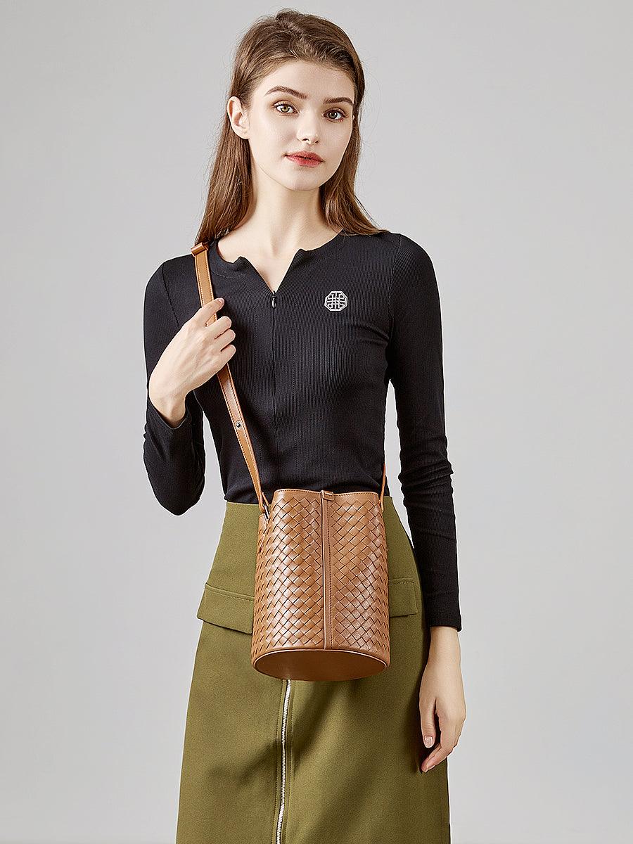 Woman modeling a tan woven lambskin leather bucket bag crossbody purse