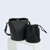 Black woven lambskin leather bucket bag with adjustable strap and drawstring pouch insert