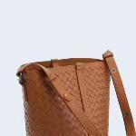 Brown woven lambskin leather bucket bag with adjustable shoulder strap, minimalist design