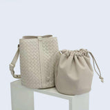 Cream woven lambskin leather bucket bag with shoulder strap and matching drawstring pouch.