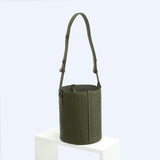 Olive green woven lambskin leather bucket bag with adjustable shoulder strap on white display