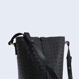 Black woven lambskin leather bucket bag with adjustable shoulder strap and textured pattern