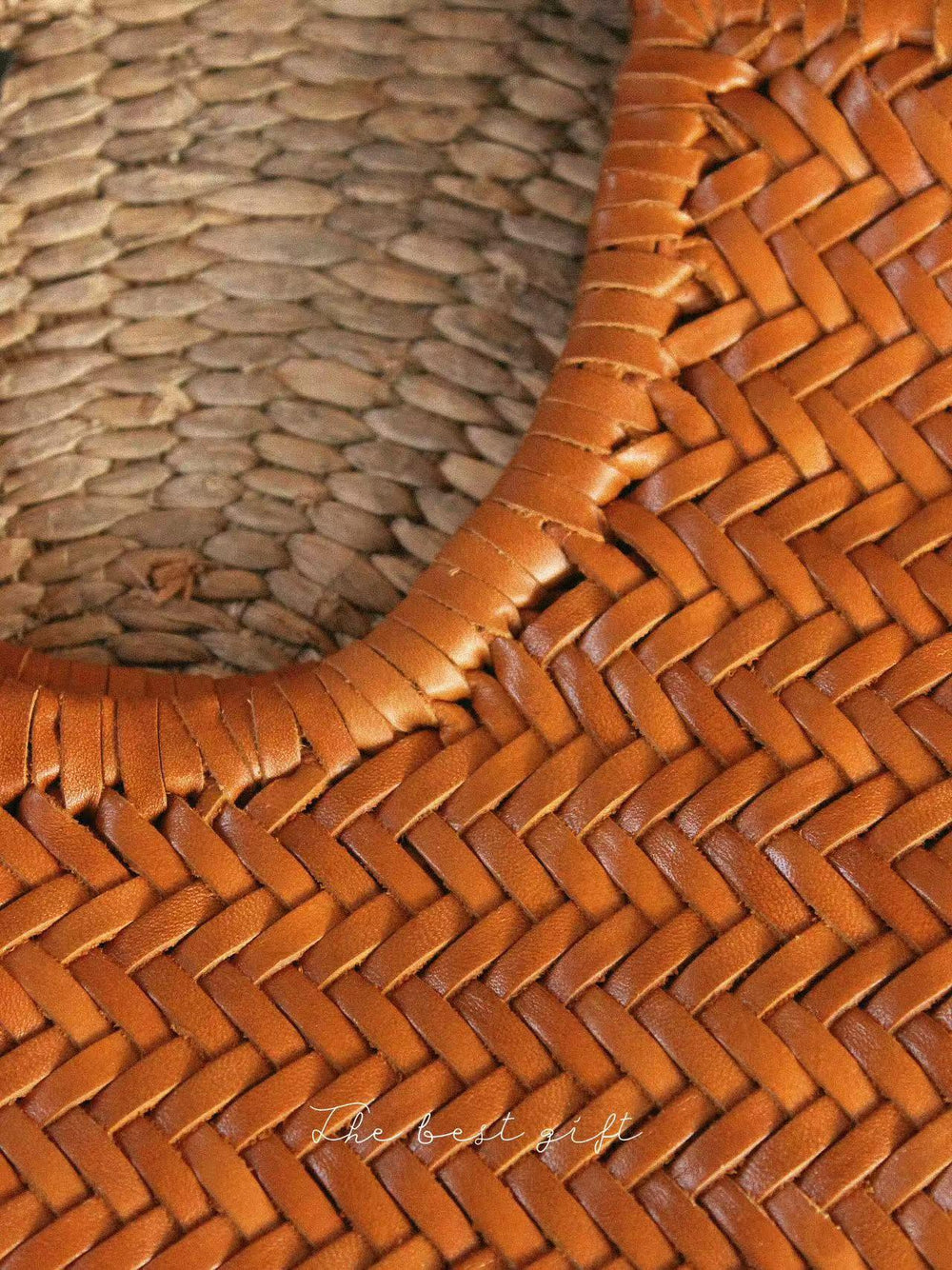 Close-up of a woven cowhide leather summer bag showing intricate basket weave texture.