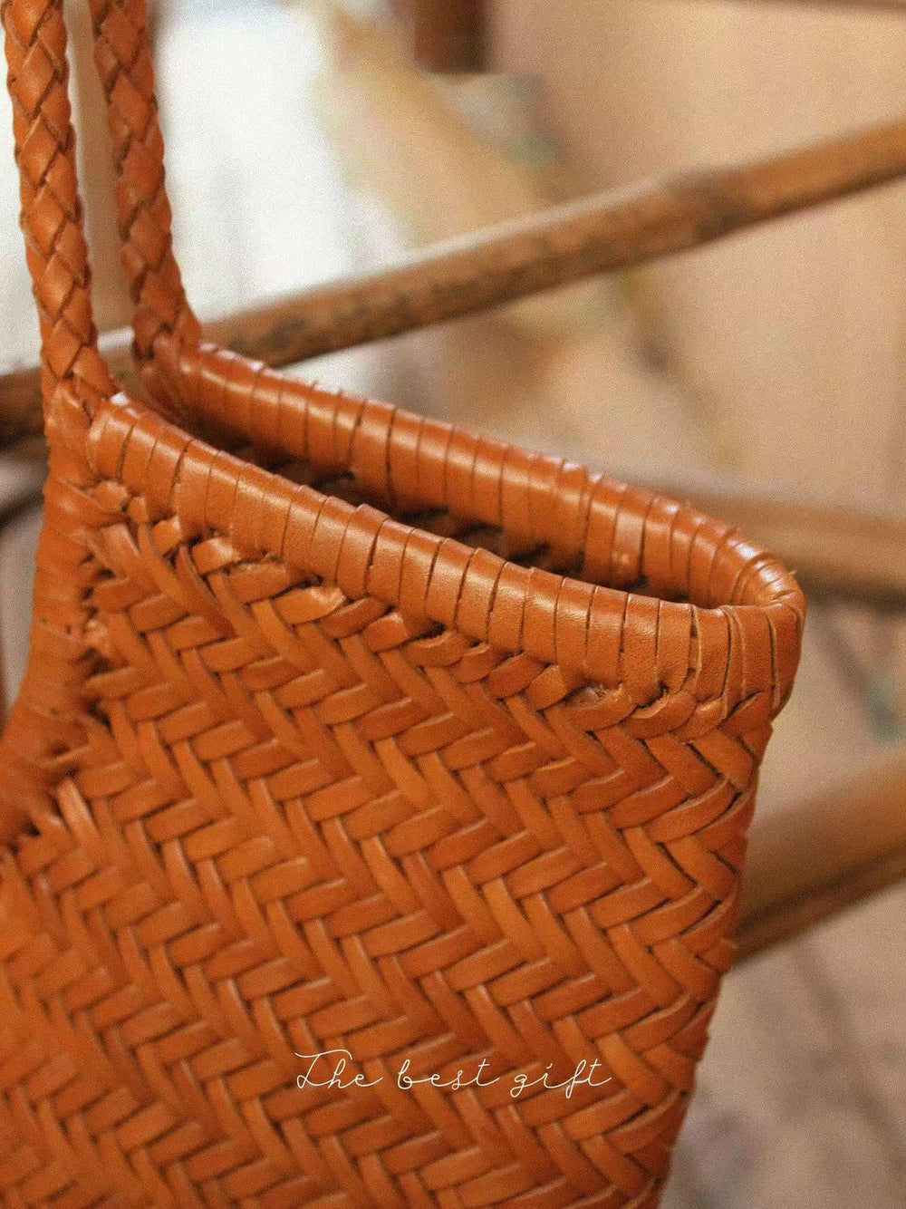 Close-up of a handmade woven cowhide leather summer bag with braided handle