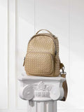 Handwoven beige lambskin leather small backpack with front pocket on white column pedestal