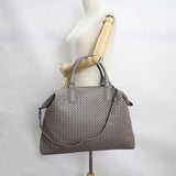 Large grey intrecciato lambskin leather tote bag with double handles and shoulder strap on mannequin