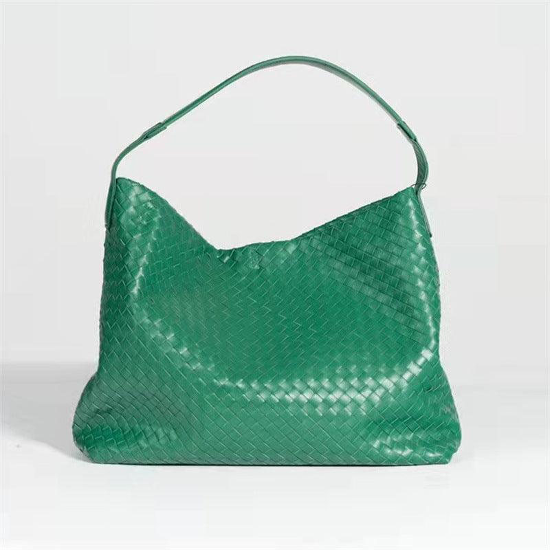 Green woven lambskin leather tote bag with a single shoulder strap on a plain background