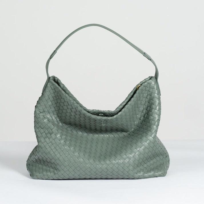 Large green woven lambskin leather tote bag with single shoulder strap on white background