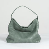 Large green woven lambskin leather tote bag with single shoulder strap on white background