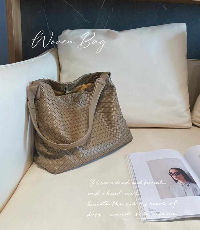 Beige Italian lambskin leather woven tote bag on a cream sofa next to an open fashion magazine