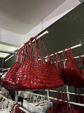 Two red woven leather trapezoidal shoulder bags with long handles wine red
