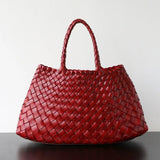 Two red woven leather trapezoidal shoulder bags with long handles wine red