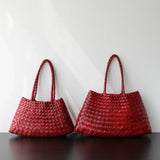 Two red woven leather trapezoidal shoulder bags with long handles wine red