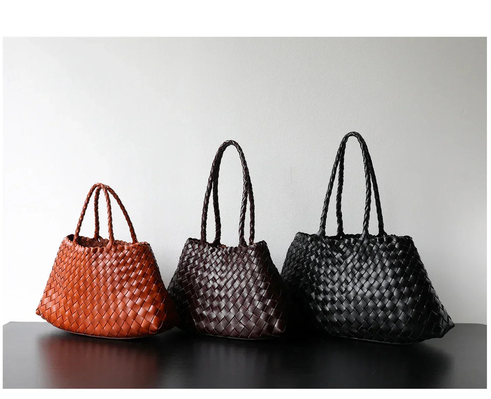 Three woven leather hobo shoulder bags in brown, dark brown, and black on a table.