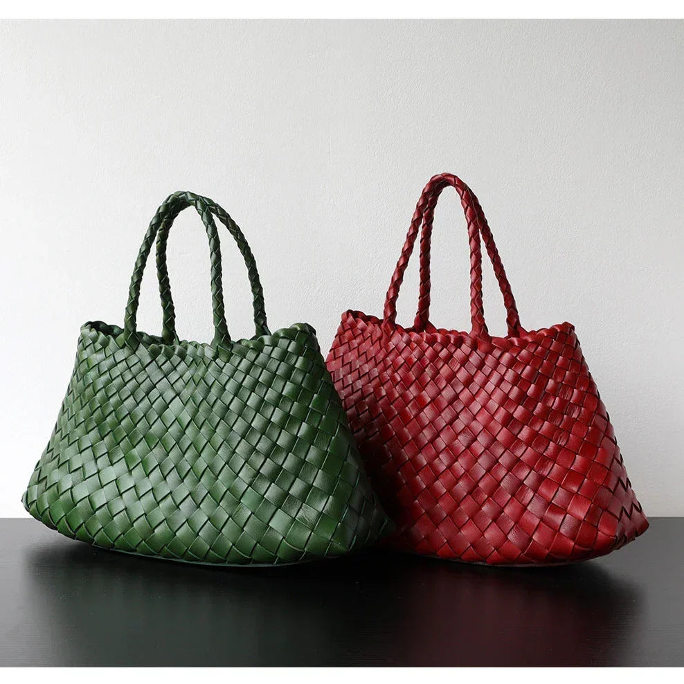 Green and red woven leather hobo trapezoidal shoulder bags with long handles on display