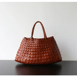 Brown woven leather hobo shoulder bag with trapezoidal shape and braided long handle