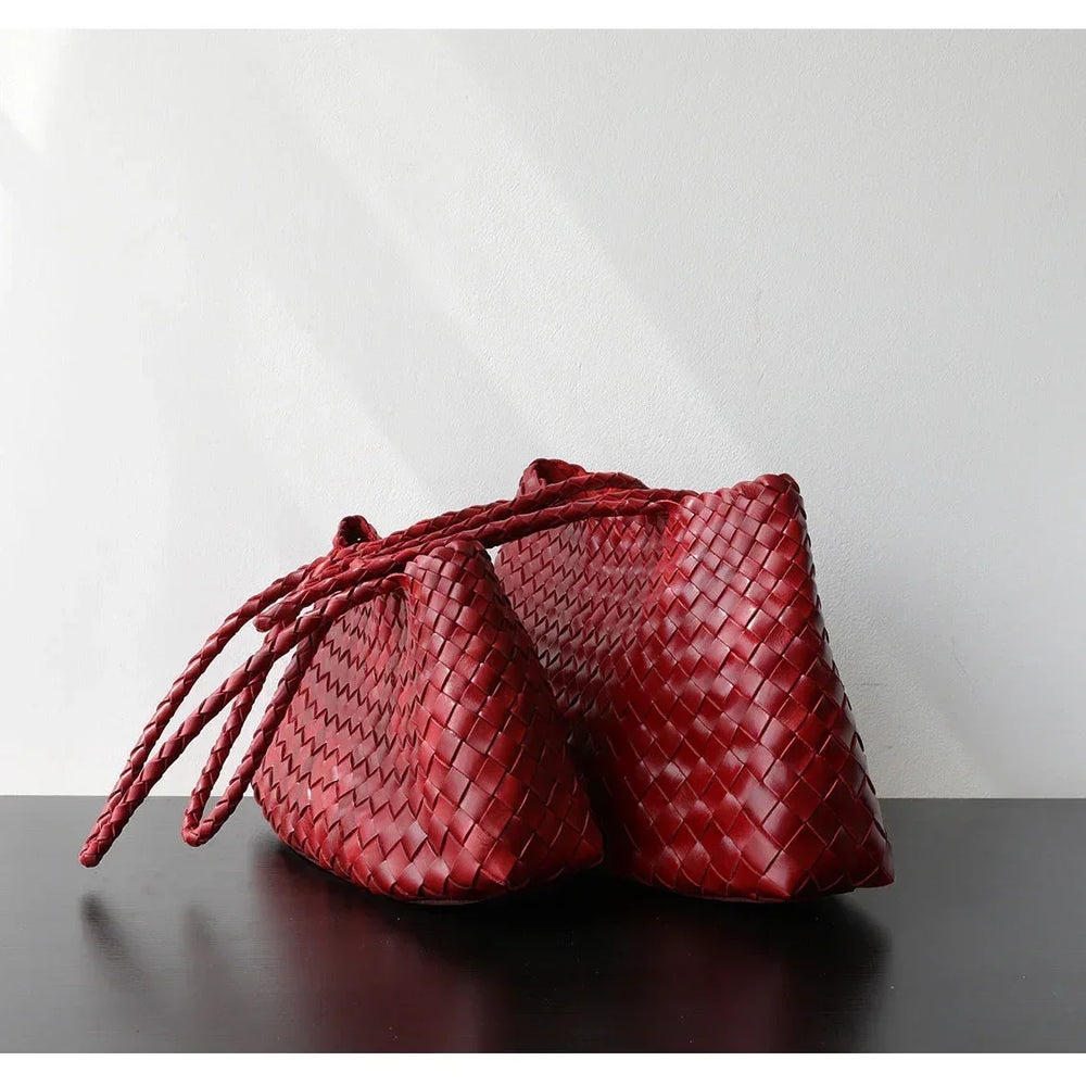 Two red woven leather trapezoidal shoulder bags with long handles wine red