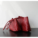 Two red woven leather trapezoidal shoulder bags with long handles wine red
