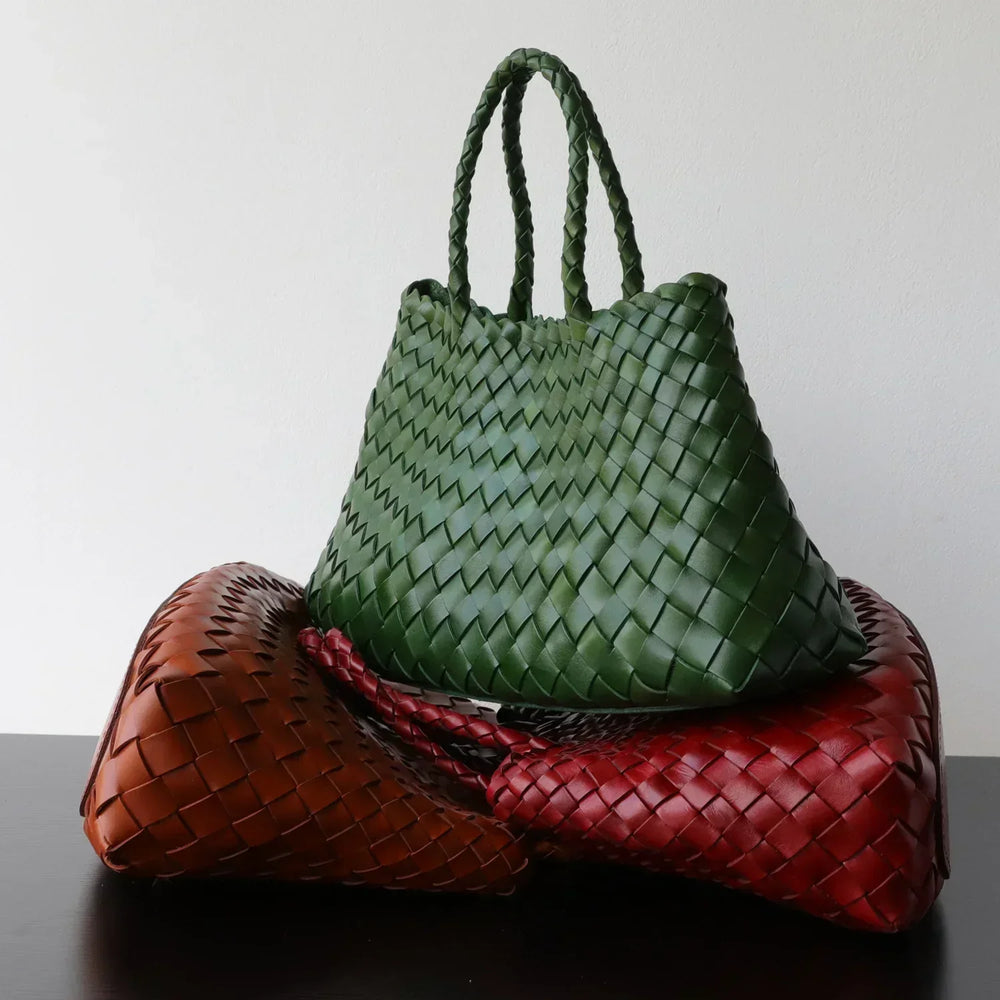 Handcrafted woven leather hobo bags in green, red, and brown with long handles