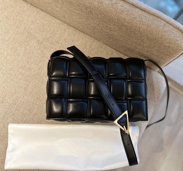 Small black lambskin leather quilted shoulder bag with handwoven design and gold buckle.