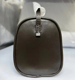 Side view of a minimalist dark brown lambskin leather box bag with smooth texture