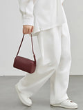 Minimalist mini lambskin leather Boston bag in burgundy, styled with white outfit