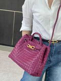 Purple woven lambskin leather shoulder bag with gold buckle, worn crossbody