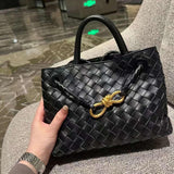 Black lambskin woven shoulder bag with braided handle and gold metal knot buckle