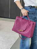 Purple lambskin woven leather shoulder bag with metal buckle, held by woman in jeans