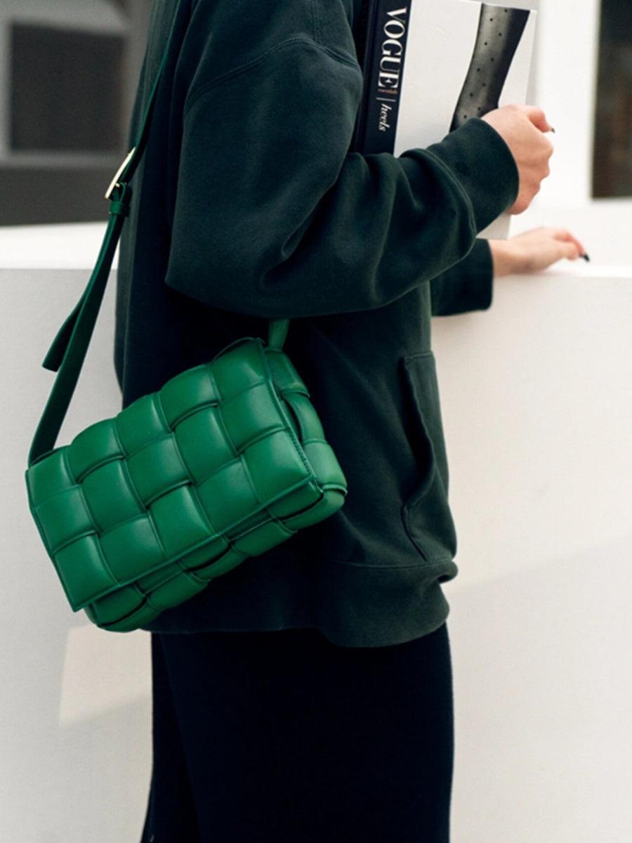 Green lambskin leather quilted shoulder bag with woven design, worn crossbody by a woman
