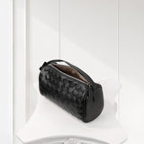 Black lambskin woven mini Boston bag with zipper, minimalist leather shoulder purse on white stand