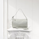 Mini woven lambskin leather handbag with detachable strap on white decorative pedestal