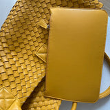Yellow handwoven vegan leather tote bag with matching detachable pouch on a white surface