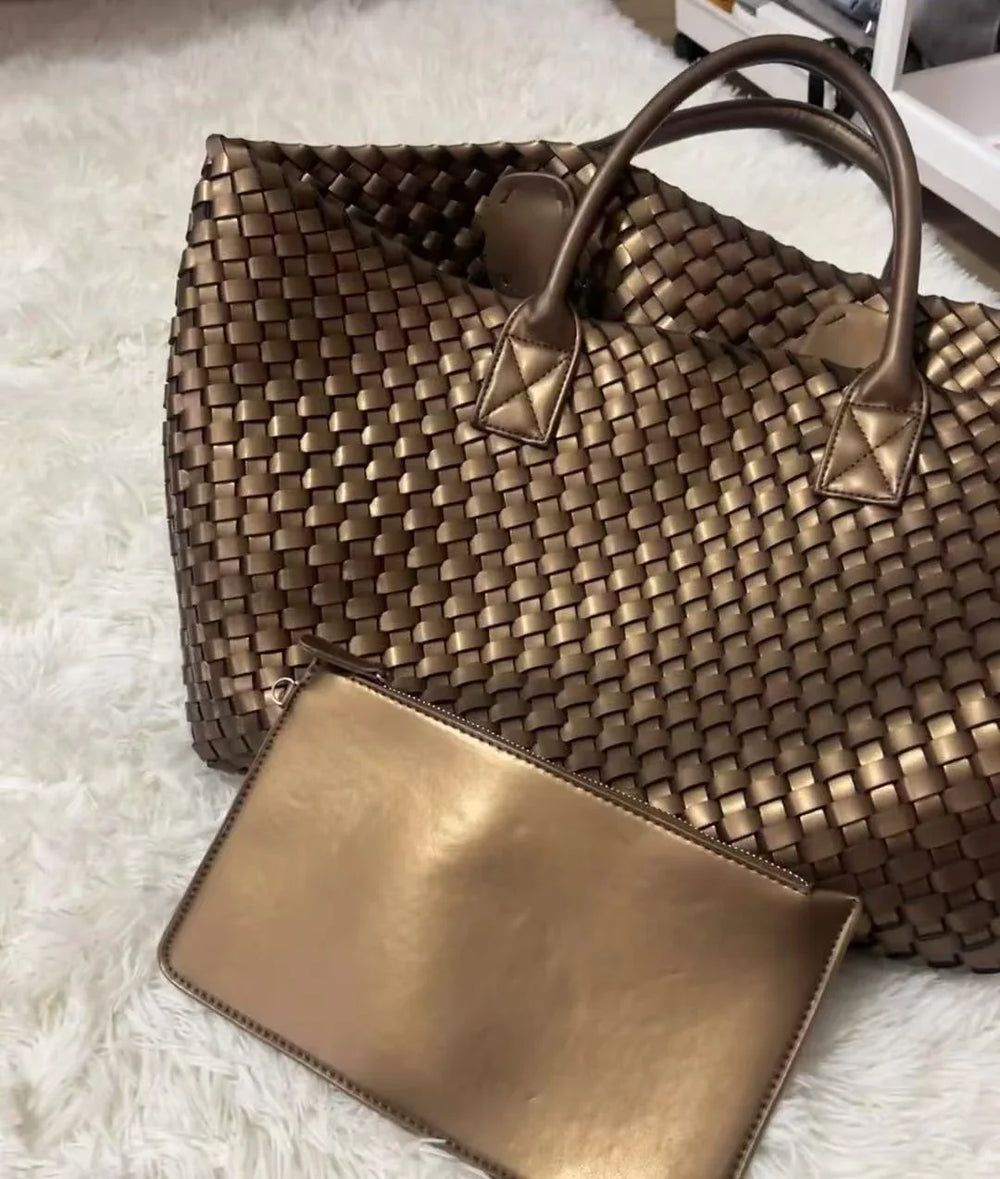 Large handwoven vegan leather tote bag in onyx with matching pouch on a white rug