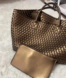 Large handwoven vegan leather tote bag in onyx with matching pouch on a white rug