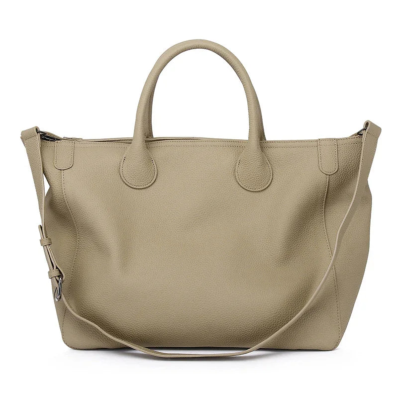 Large beige cowhide leather tote bag with shoulder strap and top handles on white background