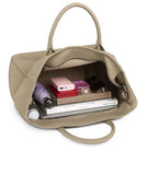 Beige leather tote bag open with books, wallet, umbrella, sunglasses, and essentials inside