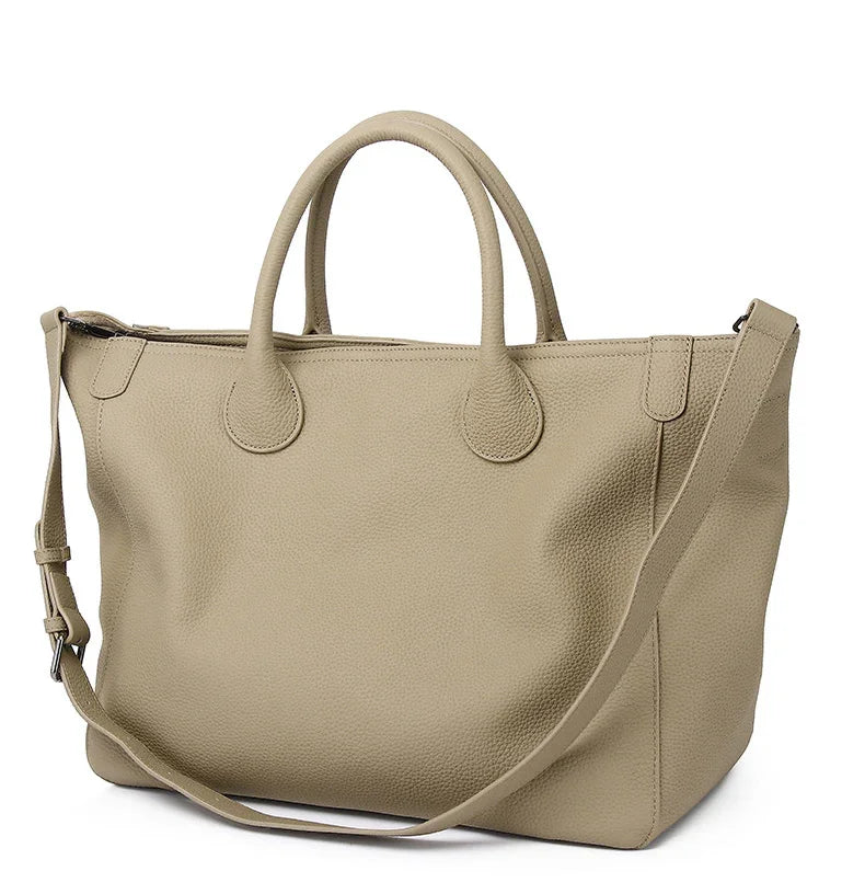 Large beige cowhide leather tote bag with shoulder strap and top handles on white background