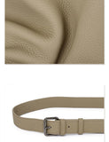 Textured taupe cowhide leather close-up and matching adjustable leather shoulder strap with metal buckle.