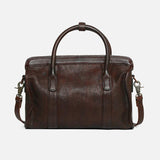 Brown leather Boston bag with top handles and detachable shoulder strap on white background