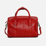 Red leather Boston bag with top handles and detachable shoulder strap on white background