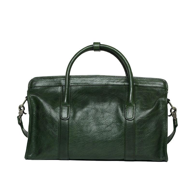 Green leather Boston bag with dual handles and detachable shoulder strap, shown on white background