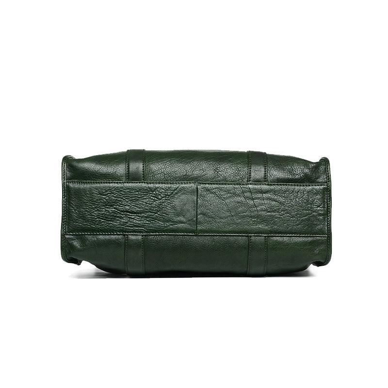 Bottom view of a green leather Boston bag with visible stitching and textured finish